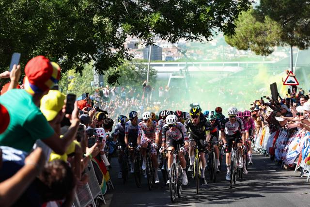 Red Bull - BORA - hansgrohe team's Belgian rider Remco Evenepoel (L), UAE Team Emirates - XRG's Slovenian rider Tadej Pogacar wearing the climber's dotted jersey and riders emerge from yellow smoke as they cycle in the Montjuic Palace ascent in the final kilometers of the 2nd stage of the 113th edition of the Tour de France cycling race, 168,5 km between Tarragona and Barcelona in northeastern Spain, on July 5, 2026. (Photo by Anne-Christine POUJOULAT / AFP)