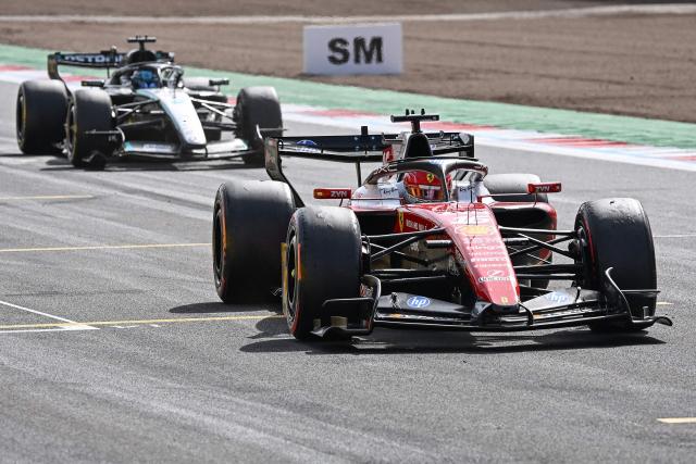 Ferrari's Monegasque driver Charles Leclerc (R) crosses the line to win the Formula One British Grand Prix at the Silverstone motor racing circuit in Silverstone, central England, on July 5, 2026. (Photo by PETER POWELL / POOL / AFP)