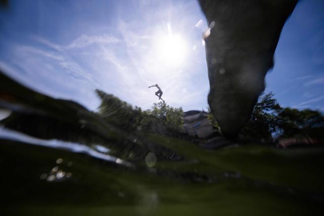 A teenager jumps into the Canal Saint Martin in central Paris, on July 5, 2026. (Photo by Olivier MORIN / AFP)
