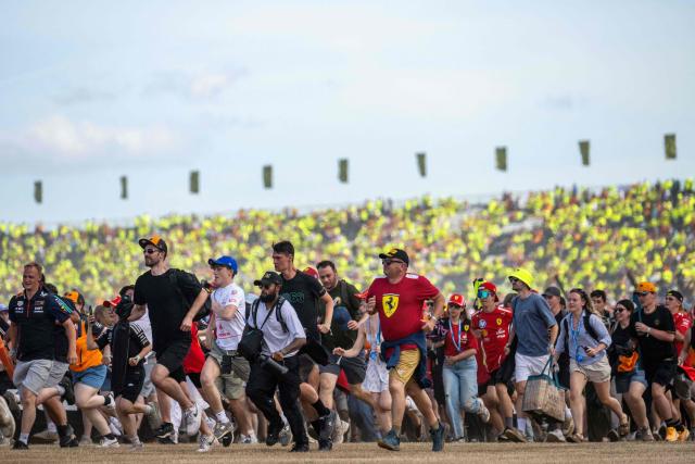 Fan run across the track following the Formula One British Grand Prix at the Silverstone motor racing circuit in Silverstone, central England, on July 5, 2026. (Photo by Ben STANSALL / AFP)