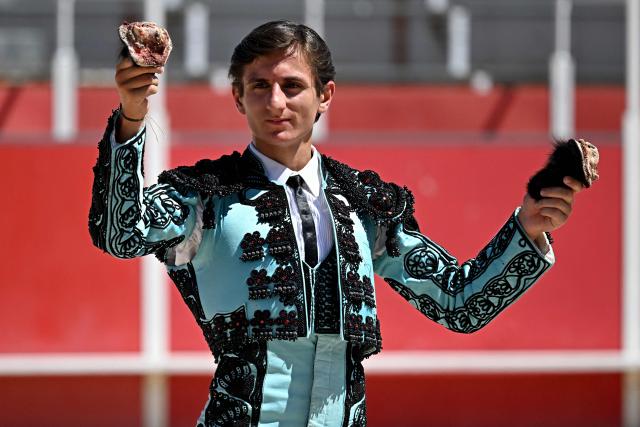 French novillero (novice bullfighter) Esteban Navarro celebrates after receiving two ears at the end of a bullfight in the Feria of Boujan-sur-Libron, near Beziers, southern France on July 5, 2026. (Photo by Gabriel BOUYS / AFP)