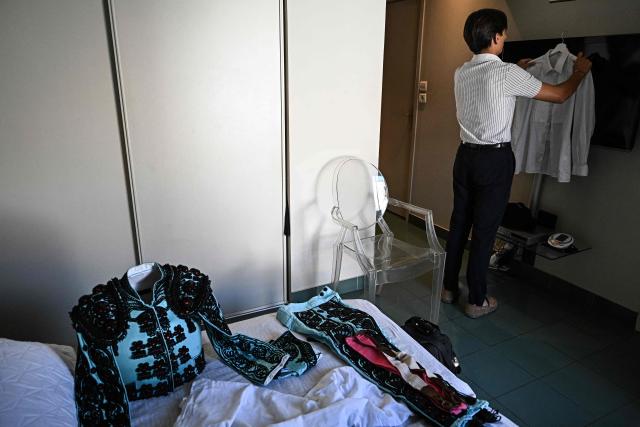 French novillero (novice bullfighter) Esteban Navarro prepares his traje de luces (traditional matador's outfit) before a bullfight during the Feria of Boujan-sur-Libron, near Beziers, southern France on July 5, 2026. (Photo by Gabriel BOUYS / AFP)