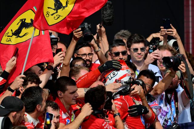 Ferrari's Monegasque driver Charles Leclerc (R) celebrates with team members after winning the Formula One British Grand Prix at the Silverstone motor racing circuit in Silverstone, central England, on July 5, 2026. (Photo by Andrej ISAKOVIC / AFP)