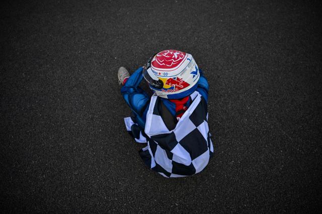 A fan of Red Bull Racing's Dutch driver Max Verstappen sits on the track following the Formula One British Grand Prix at the Silverstone motor racing circuit in Silverstone, central England, on July 5, 2026. (Photo by Ben STANSALL / AFP)