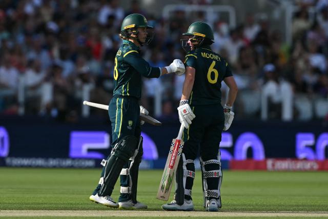Australia's Phoebe Litchfield (L) congratulates Australia's Beth Mooney (R) on reaching 50 during the ICC Women's T20 cricket world cup 2026 final between Australia and England, at Lord's in London on July 5, 2026. (Photo by JUSTIN TALLIS / AFP)