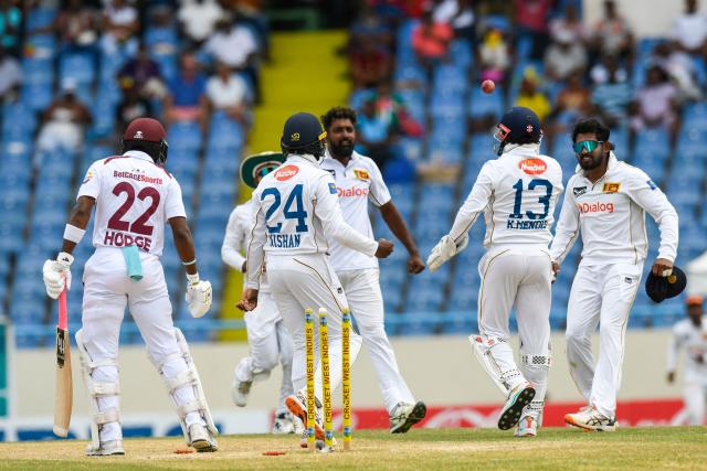 Kavem Hodge (L) of West Indies is dismissed by Prabath Jayasuriya (3L) of Sri Lanka during the 3rd day of the 2nd Test between Sri Lanka and West Indies at Vivian Richards Cricket Stadium in North Sound, Antigua and Barbuda, on July 5, 2026. (Photo by Randy Brooks / AFP)