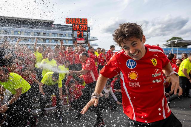 Ferrari's Monegasque driver Charles Leclerc celebrates with his team after winning the Formula One British Grand Prix at the Silverstone motor racing circuit in Silverstone, central England, on July 5, 2026. (Photo by Ben STANSALL / AFP)