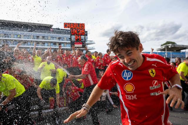 Ferrari's Monegasque driver Charles Leclerc celebrates with his team after winning the Formula One British Grand Prix at the Silverstone motor racing circuit in Silverstone, central England, on July 5, 2026. (Photo by Ben STANSALL / AFP)