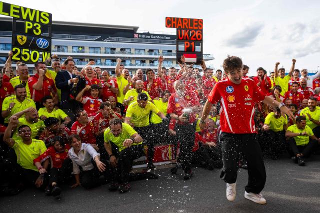 Ferrari's Monegasque driver Charles Leclerc celebrates with his team after winning the Formula One British Grand Prix at the Silverstone motor racing circuit in Silverstone, central England, on July 5, 2026. (Photo by Ben STANSALL / AFP)