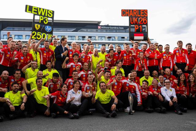 First-placed Ferrari's Monegasque driver Charles Leclerc and third-placed Ferrari's British driver Lewis Hamilton celebrate with their team following the Formula One British Grand Prix at the Silverstone motor racing circuit in Silverstone, central England, on July 5, 2026. (Photo by Ben STANSALL / AFP)