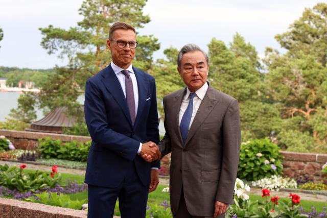 Finnish President Alexander Stubb (L) shakes hands with Chinese Foreign Minister Wang Yi at the President's summer residence Kultaranta in Naantali, Finland on July 5, 2026. Minister Wang Yi is currently touring the Nordic countries. (Photo by Laura Ukkonen / Lehtikuva / AFP) / Finland OUT