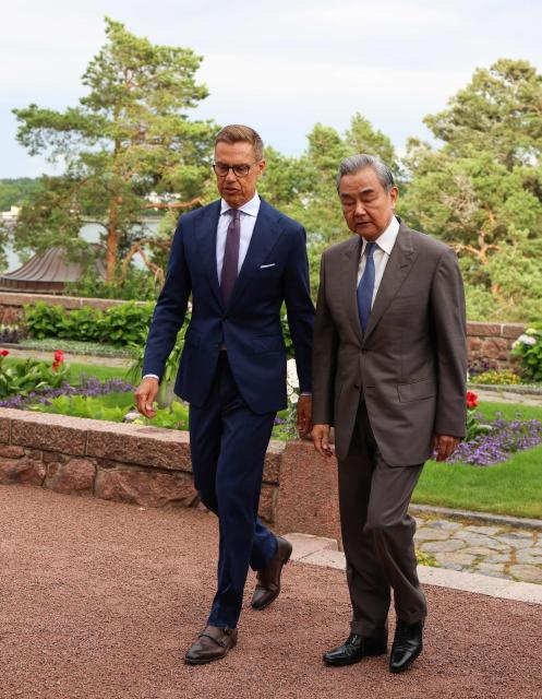 Finnish President Alexander Stubb (L) walks with Chinese Foreign Minister Wang Yi at the President's summer residence Kultaranta in Naantali, Finland on July 5, 2026. Minister Wang Yi is currently touring the Nordic countries. (Photo by Laura Ukkonen / Lehtikuva / AFP) / Finland OUT