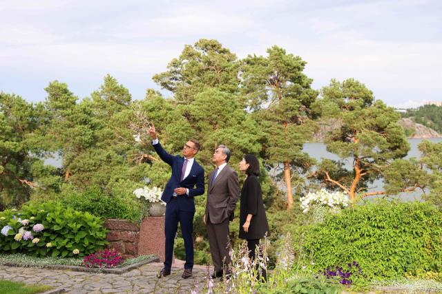 Finnish President Alexander Stubb (L) welcomes Chinese Foreign Minister Wang Yi as they meet at the President's summer residence Kultaranta in Naantali, Finland on July 5, 2026. Minister Wang Yi is currently touring the Nordic countries. (Photo by Laura Ukkonen / Lehtikuva / AFP) / Finland OUT