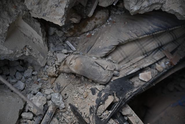 EDITORS NOTE: Graphic content / View of the corpse of a child beneath the rubble in Macuto, Vargas state, Venezuela, on July 5, 2026, following the June 24 twin earthquakes. The devastating earthquakes that struck Venezuela eleven days ago have now claimed nearly 3,000 lives, according to the latest figures released on July 4, 2026, as foreign rescue teams wind down their operations to find survivors. (Photo by Raul ARBOLEDA / AFP)