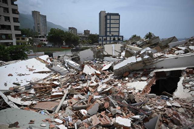 EDITORS NOTE: Graphic content / View of rubble in Macuto, Vargas state, Venezuela, on July 5, 2026, following the June 24 twin earthquakes. The devastating earthquakes that struck Venezuela eleven days ago have now claimed nearly 3,000 lives, according to the latest figures released on July 4, 2026, as foreign rescue teams wind down their operations to find survivors. (Photo by Raul ARBOLEDA / AFP)