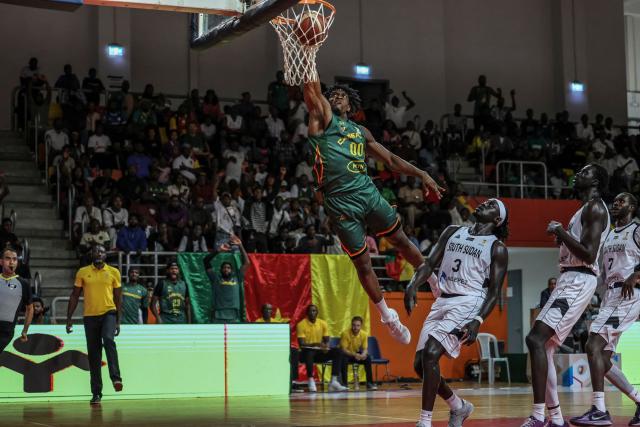 TOPSHOT - Cameroon's #00 Paul Eboua scores a point during a basketball match game between Cameron vs South Soudan played on the third day of the African qualifying for the 2027 Men's Basketball World Cup in Qatar, in Douala on July 5, 2026. (Photo by Daniel BELOUMOU OLOMO / AFP)