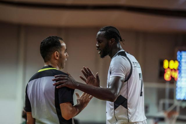 South Soudan's #7 Mangok Mathiang (R) talks with the referee during a basketball match game between Cameron vs South Soudan played on the third day of the African qualifying for the 2027 Men's Basketball World Cup in Qatar, in Douala on July 5, 2026. (Photo by Daniel BELOUMOU OLOMO / AFP)