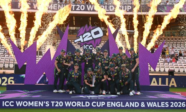 Australia's captain Sophie Molineux holds the trophy as Australia celebrate on the podium after the ICC Women's T20 cricket world cup 2026 final between Australia and England, at Lord's in London on July 5, 2026. Australia thrashed England by seven wickets to win the Women's T20 World Cup final at Lord's on Sunday. Victory gave Australia a record-extending seventh Women's T20 global title as they chased down a target of 151 with 17 balls to spare. (Photo by JUSTIN TALLIS / AFP)