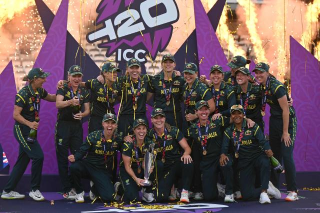 Australia's captain Sophie Molineux holds the trophy as Australia celebrate on the podium after the ICC Women's T20 cricket world cup 2026 final between Australia and England, at Lord's in London on July 5, 2026. Australia thrashed England by seven wickets to win the Women's T20 World Cup final at Lord's on Sunday. Victory gave Australia a record-extending seventh Women's T20 global title as they chased down a target of 151 with 17 balls to spare. (Photo by JUSTIN TALLIS / AFP)