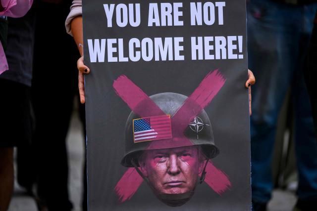 A protestor holds a sign depicting the US President wearing a helmet during an anti-NATO demonstration in Istanbul, ahead of a NATO summit, on July 5, 2026. The next NATO summit will take place in Ankara on July 7-8 and is expected to be attended by 32 leaders including US President. (Photo by Yasin AKGUL / AFP)