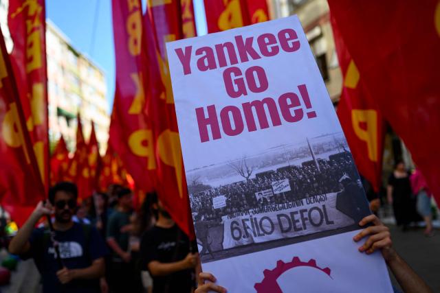 Protestors hold signs reading "Yankee go home" and wave flags during an anti-NATO demonstration in Istanbul, ahead of a NATO summit, on July 5, 2026. The next NATO summit will take place in Ankara on July 7-8 and is expected to be attended by 32 leaders including US President. (Photo by Yasin AKGUL / AFP)