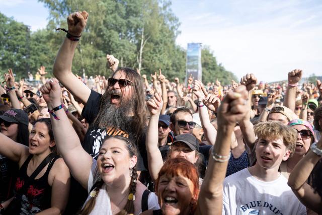 Festivalgoers dance as Swedish garage punk band The Hives performs on stage on the last day of the 36th edition of the Eurockeennes de Belfort music festival in Sermamagny, eastern France on July 5, 2026. (Photo by ROMEO BOETZLE / AFP)