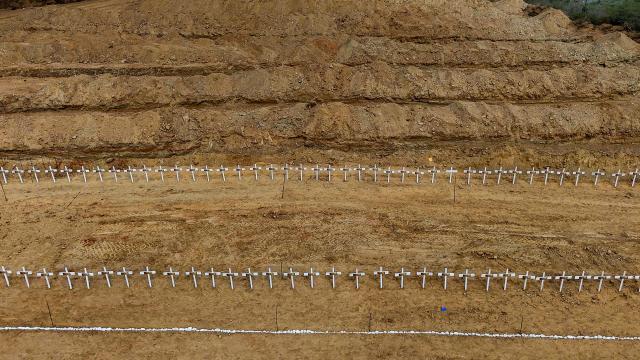 This aerial view shows plots containing the graves of unidentified individuals, victims of the twin earthquakes, at La Esperanza Cemetery in Catia La Mar, La Guaira state, northeast of Caracas, on July 5, 2026. Venezuela's devastating twin earthquakes killed nearly 3,000, updated official figures showed on July 4, as international rescue teams began winding down search operations for survivors in the rubble of the disaster. (Photo by Miguel MEDINA / AFP)
