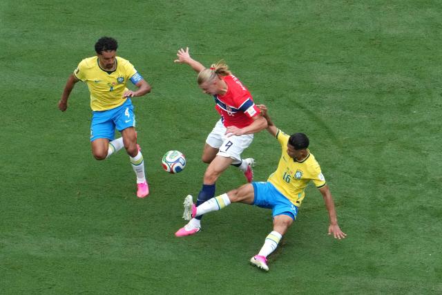 Norway's forward #09 Erling Braut Haaland, Brazil's defenders #04 Marquinhos and #16 Douglas Santos fight for the ball during the 2026 World Cup round of 16 football match between Brazil and Norway at the New York/New Jersey Stadium in East Rutherford on July 5, 2026.  (Photo by TIMOTHY A. CLARY / AFP)