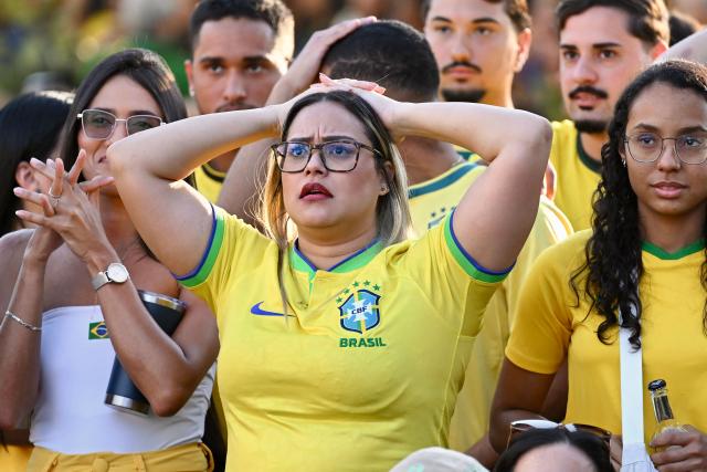 Brazilian fans react as they watch the live broadcast of the 2026 FIFA World Cup Round of 16 football match between Brazil and Norway on a street in Brasilia, on July 5, 2026. (Photo by Evaristo Sa / AFP)