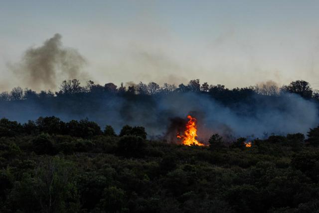 This photograph shows a wildfire burning near Montalba-le-Chateau, in the Pyrenees-Orientales department, southern France on July 5, 2026. A wildfire broke out on July 4 at around 19h30 (1730 GMT) in a hard-to-reach massif near Trevillach, in the Pyrenees-Orientales department of southern France and spread rapidly overnight. More than 10,000 residents are currently being evacuated as the wildfire spreads rapidly, having burned around 2,000 hectares. (Photo by Jc Milhet / AFP)