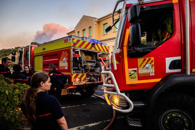 Firefighters refill their trucks with water in the village Montalba-le-Chateau, in the Pyrenees-Orientales department, southern France on July 5, 2026. A wildfire broke out on July 4 at around 19h30 (1730 GMT) in a hard-to-reach massif near Trevillach, in the Pyrenees-Orientales department of southern France and spread rapidly overnight. More than 10,000 residents are currently being evacuated as the wildfire spreads rapidly, having burned around 2,000 hectares. (Photo by Jc Milhet / AFP)