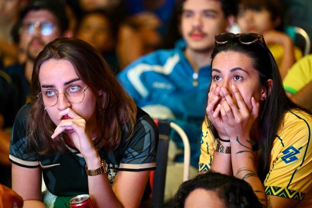 Brazilian fans react as they watch the live broadcast of the 2026 FIFA World Cup Round of 16 football match between Brazil and Norway on a street in Brasilia, on July 5, 2026. (Photo by Evaristo Sa / AFP)