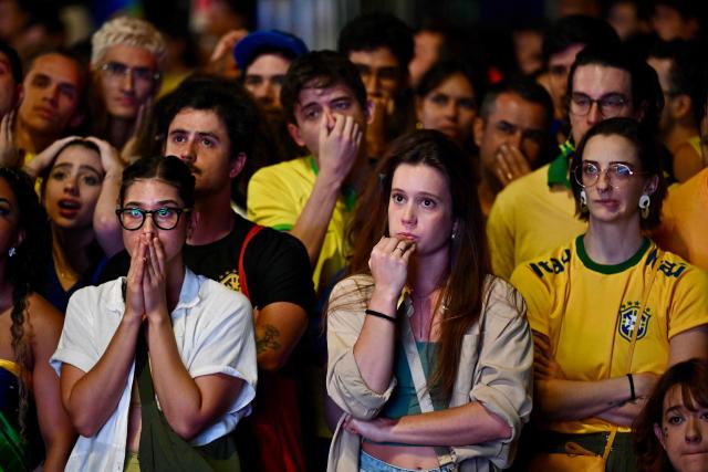 Brazilian fans react as they watch the live broadcast of the 2026 FIFA World Cup Round of 16 football match between Brazil and Norway on a street in Brasilia, on July 5, 2026. (Photo by Evaristo Sa / AFP)