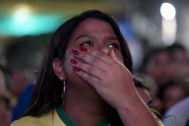 A Brazilian fan reacts while watching the 2026 FIFA World Cup Round of 16 football match between Brazil and Norway during the Alzirao festival in the Tijuca neighborhood, North Zone of Rio de Janeiro, Brazil, on July 5, 2026. (Photo by TERCIO TEIXEIRA / AFP)