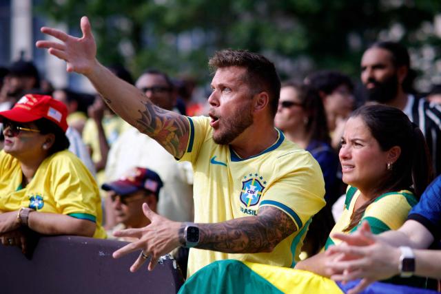 A Brazilian fan react while watching the 2026 World Cup round of 16 football match between Brazil and Norway at a watch party in Hudson Yards Backyard in New York City on July 5, 2026. (Photo by Leonardo MUNOZ / AFP)