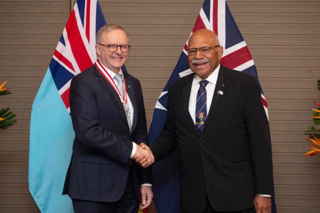 Australian Prime Minister Anthony Albanese (L) shakes hands with Fiji's Prime Minister Sitiveni Rabuka (R) before a bilateral meeting at the Grand Pacific Hotel in Suva on July 6, 2026. Australia signed a new defence alliance with Fiji on July 6, bolstering ties with its South Pacific island neighbor as it seeks to outmanoeuvre China in the region. (Photo by Leon LORD / AFP)