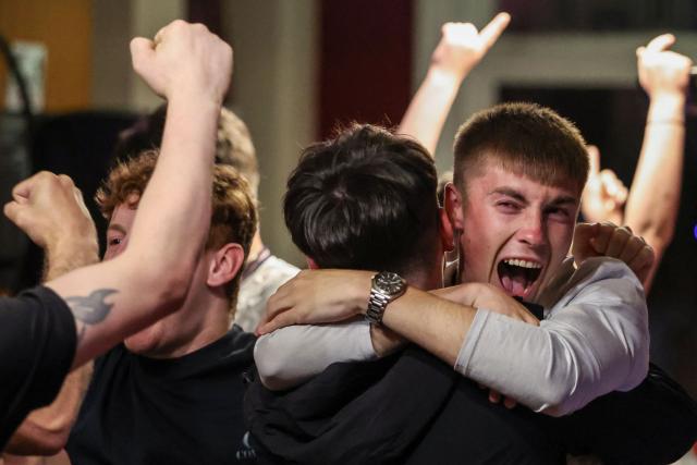 England's supporters celebrate a goal during the 2026 World Cup round of 16 football match between England and Mexico, at The Clock pub in Hebburn, north-east England early on July 6, 2026. (Photo by SCOTT HEPPELL / AFP)