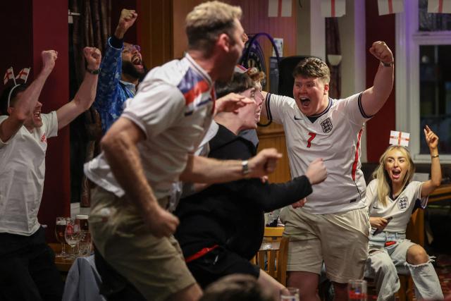 England's supporters celebrate a goal during the 2026 World Cup round of 16 football match between England and Mexico, at The Clock pub in Hebburn, north-east England early on July 6, 2026. (Photo by SCOTT HEPPELL / AFP)