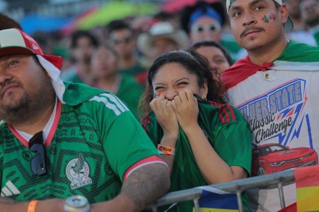 Mexico fans react after England scored their third goal during the 2026 World Cup round of 16 football match between the Mexico and England at a watch party at Ace Mission Studios, in Los Angeles, California, on July 5, 2026. (Photo by Etienne LAURENT / AFP)