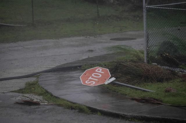 A traffic sign lies on the ground after being knocked down by strong winds brought by Super Typhoon Bavi in Guam on July 6, 2026. (Photo by Yuichi YAMAZAKI / AFP)