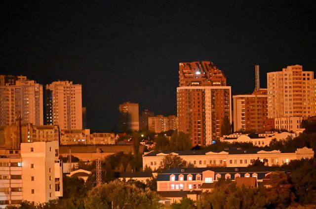 Buildings are illuminated after an explosion during a Russian missile strike on the Ukrainian capital of Kyiv on July 6, 2026, amid the Russian invasion in Ukraine. Russian strikes on Kyiv killed three people on July 6, authorities said, the second deadly attack on the Ukrainian capital in less than a week. (Photo by Sergei SUPINSKY / AFP)