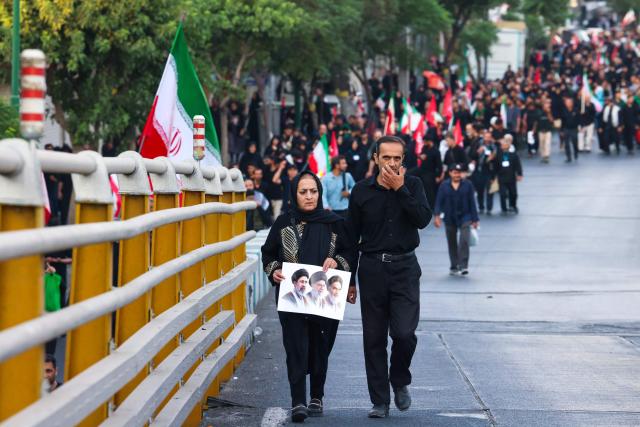 People arrive for the funeral procession of Iran's slain Supreme Leader Ali Khamenei in Tehran July 6, 2026. Massive crowds are expected on July 6 for the funeral procession of late Iranian supreme leader Ali Khamenei in Tehran, with authorities hoping to avoid a repeat of the chaos that accompanied his predecessor's funeral. (Photo by ATTA KENARE / AFP) / 