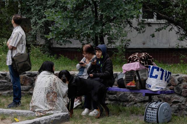 Local residents gather near a damaged residential building following a Russian missile strike on the Ukrainian capital of Kyiv on July 6, 2026, amid the Russian invasion in Ukraine. Russia struck Ukraine's Kyiv region with ballistic missiles on July 6, killing at least eight people and wounding dozens, authorities said, on the eve of a NATO summit in Turkey. (Photo by Tetiana DZHAFAROVA / AFP)