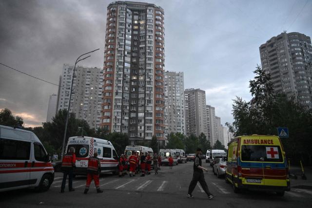 Emergency vehicles are parked near a multistorey residential building damaged following a Russian missile strike on the Ukrainian capital of Kyiv on July 6, 2026, amid the Russian invasion in Ukraine. Russia struck Ukraine's Kyiv region with ballistic missiles on July 6, killing at least eight people and wounding dozens, authorities said, on the eve of a NATO summit in Turkey. (Photo by Genya Savilov / AFP)