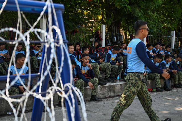 Police sit on standby outside the Senate of the Philippines in Pasay, Metro Manila on July 6, 2026. The Philippine Senate is set to open Vice President Sara Duterte's impeachment trial on July 6, with her political career -- and a planned 2028 presidential run -- in the balance. (Photo by Jam STA ROSA / AFP)