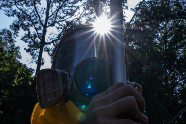 A Malaysian NGO member wears a gas mask during the "No Rare Earth for Genocide" protest in Kuala Lumpur on July 6, 2026. The coalition urged the government to halt rare earth exports linked to military supply chains and strengthen transparency and environmental safeguards. (Photo by Mohd Rasfan / AFP)