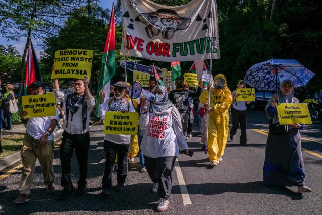 Malaysian NGOs display placards during the "No Rare Earth for Genocide" protest in Kuala Lumpur on July 6, 2026. The coalition urged the government to halt rare earth exports linked to military supply chains and strengthen transparency and environmental safeguards. (Photo by Mohd Rasfan / AFP)