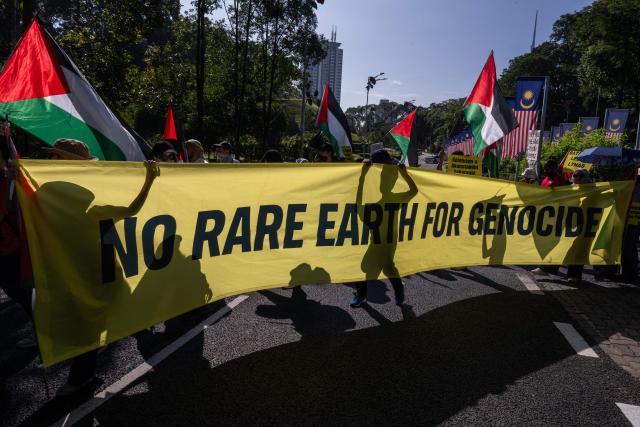 Malaysian NGOs carry a banner during the "No Rare Earth for Genocide" protest in Kuala Lumpur on July 6, 2026. The coalition urged the government to halt rare earth exports linked to military supply chains and strengthen transparency and environmental safeguards. (Photo by Mohd Rasfan / AFP)