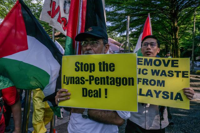 Malaysian NGOs display placards during the "No Rare Earth for Genocide" protest in Kuala Lumpur on July 6, 2026. The coalition urged the government to halt rare earth exports linked to military supply chains and strengthen transparency and environmental safeguards. (Photo by Mohd Rasfan / AFP)