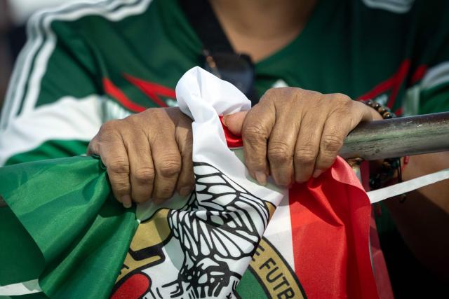 A Mexico fan grips her Mexican flag as Mexico loses their 2026 World Cup round of 16 football match against England during a watch party at Ace Mission Studios, in Los Angeles, California, on July 5, 2026. (Photo by ETIENNE LAURENT / AFP)